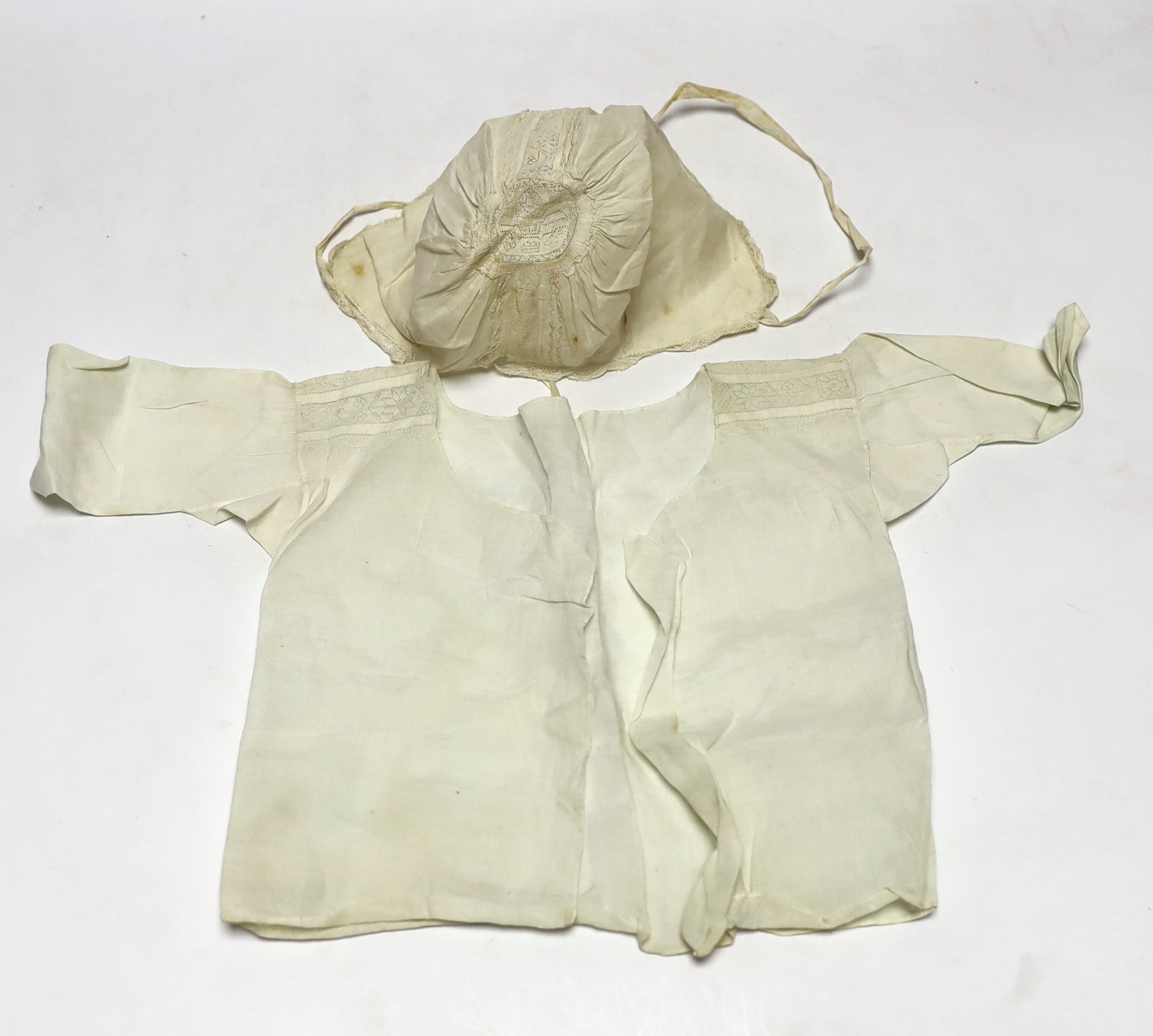 An early 18th century Hollie point insertion baby’s linen vest, three baby bonnets with Hollie point insertions and an early 18th century pair of Flemish bobbin lace lappets, a partly finished needlepoint length of lace,